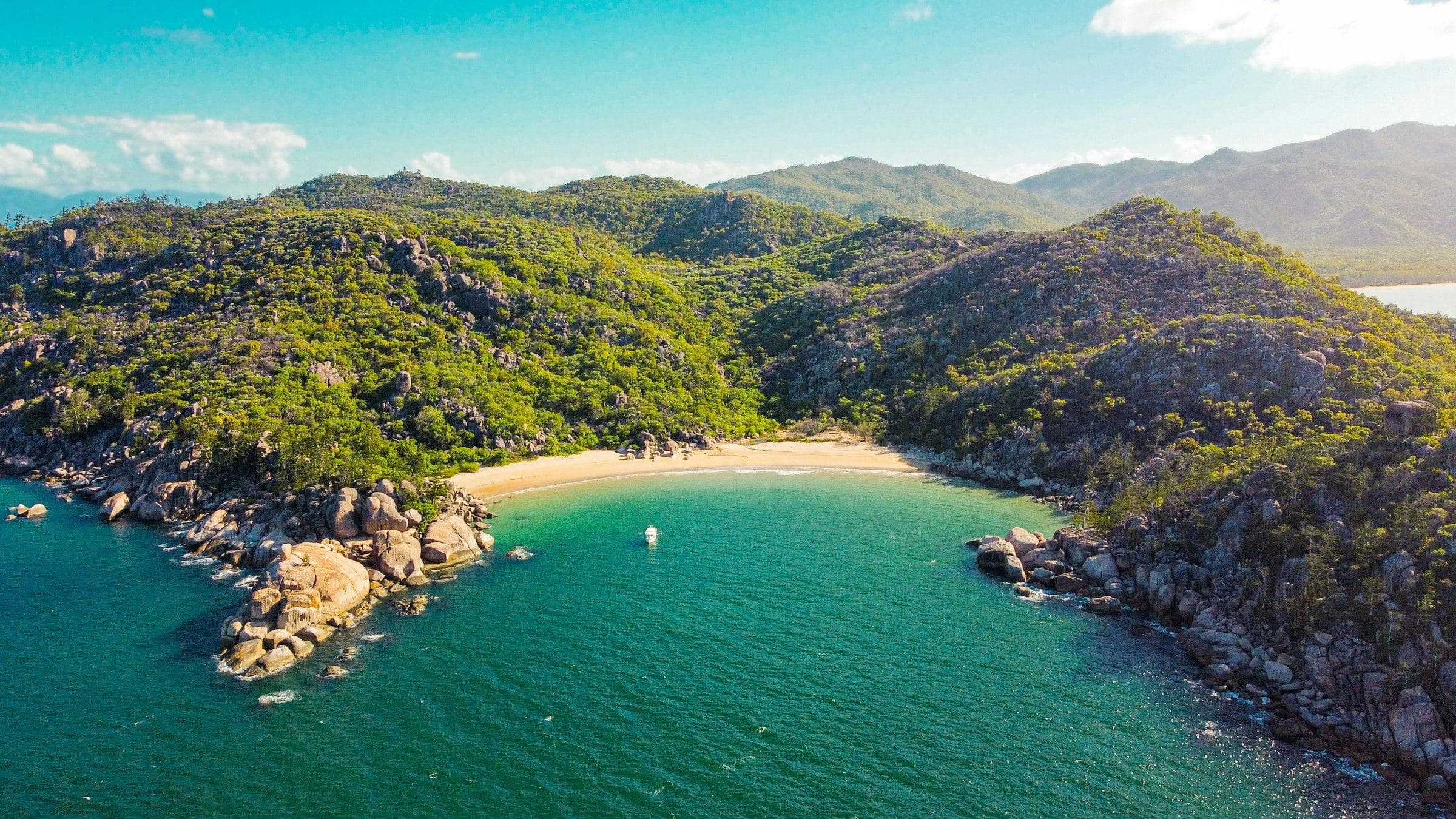 A turquoise bay below green headlands at Magnetic Island, Queensland, from above